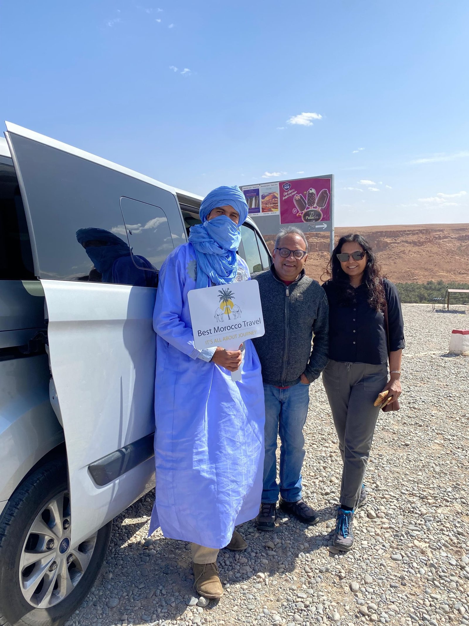 Our driver-guide with guests beside the private van