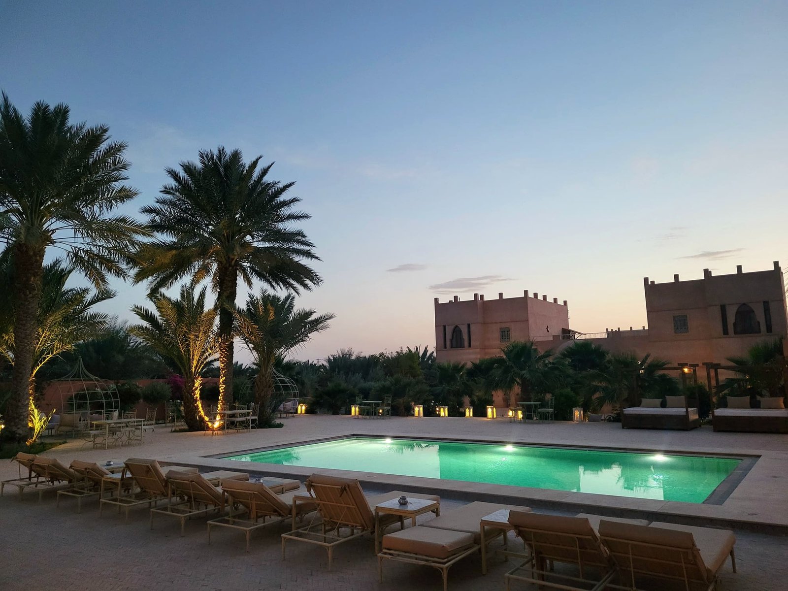Kasbah hotel pool at dusk on the road to the Sahara