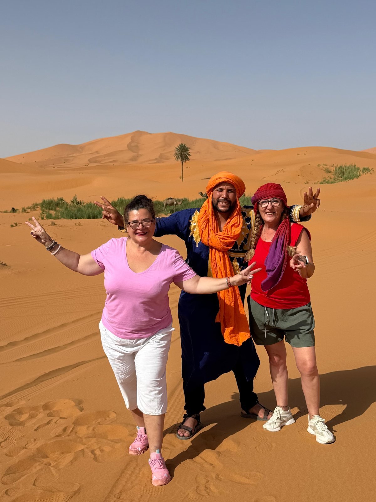 Our guide with guests in the Erg Chebbi dunes